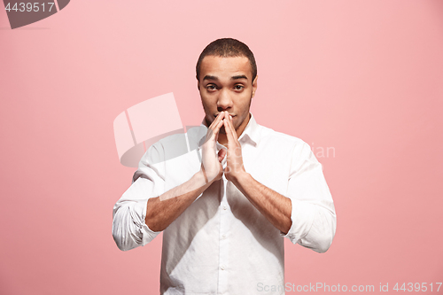 Image of Young serious thoughtful businessman. Doubt concept.