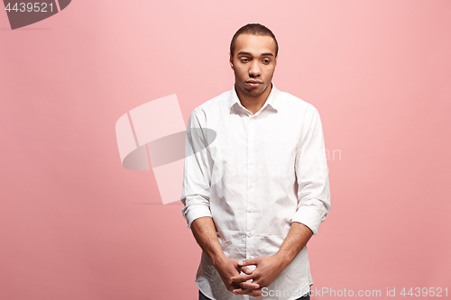 Image of Beautiful man looking suprised and bewildered isolated on pink