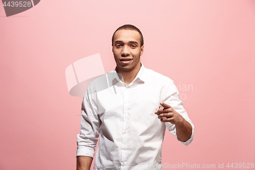 Image of The happy business man point you and want you, half length closeup portrait on pink background.