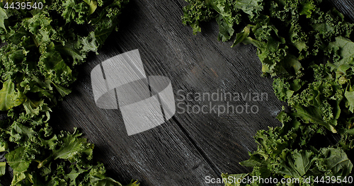Image of Composed green salad leaves on wood