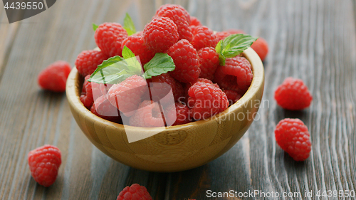 Image of Fresh raspberry on wooden table 