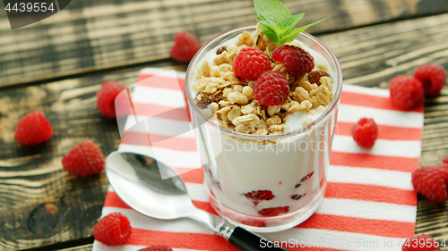 Image of Served yogurt with raspberry on napkin