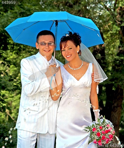 Image of Bridegroom and bride with the umbrella