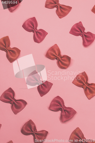 Image of Pink pasta farfalle lies diagonally