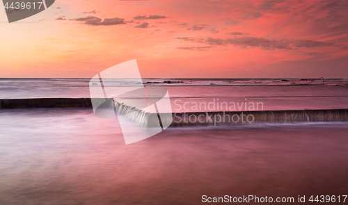 Image of Sunrise skies and brilliant colour over rockpool