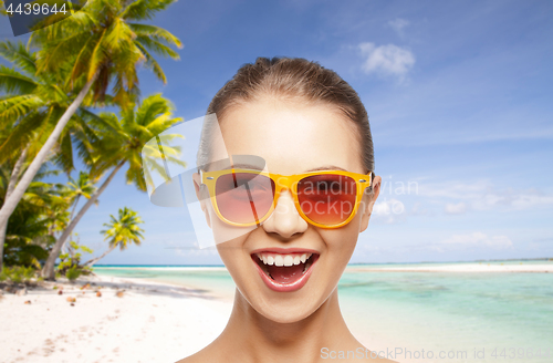 Image of happy woman or teenage girl in sunglasses on beach