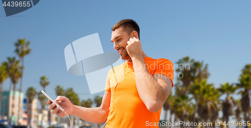 Image of man with smartphone and earphones in los angeles