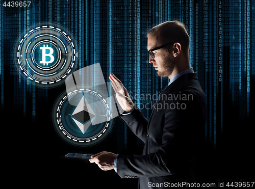 Image of businessman with tablet pc and cryptocurrency