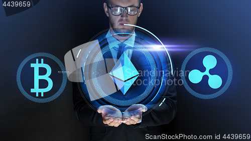 Image of businessman with at cryptocurrency icons