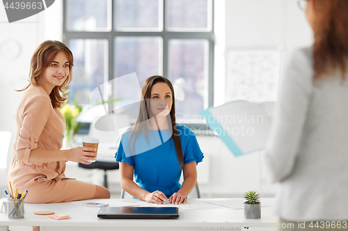 Image of businesswomen at presentation in office