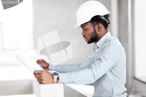 Image of african architect in helmet with blueprint