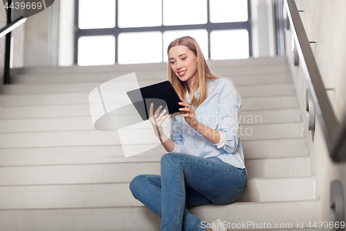 Image of woman or student with tablet pc sitting on stairs