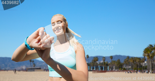 Image of woman with fitness tracker exercising outdoors