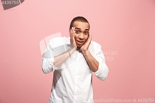 Image of Handsome man looking suprised isolated on pink