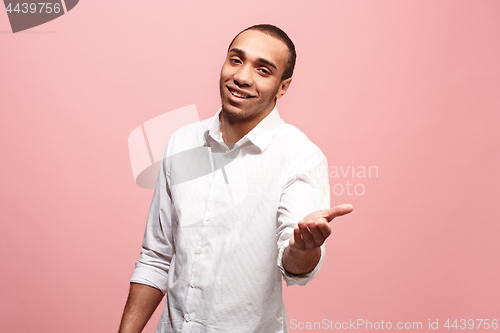 Image of The happy business man point you and want you, half length closeup portrait on pink background.