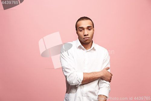 Image of Let me think. Doubtful pensive man with thoughtful expression making choice against pink background