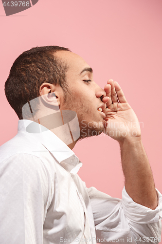 Image of Isolated on pink young casual man shouting at studio