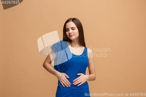 Image of The happy business woman standing and smiling against pastel background.