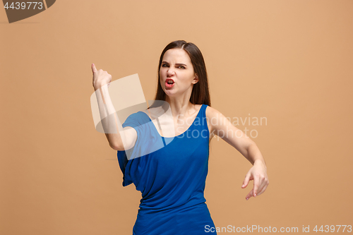 Image of The young emotional angry woman screaming on pastel studio background