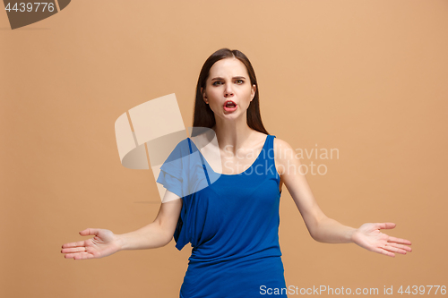 Image of Portrait of an argue woman looking at camera isolated on a pastel background