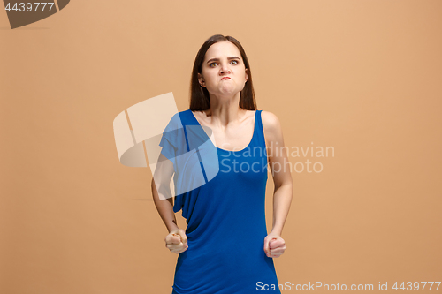 Image of Portrait of an angry woman looking at camera isolated on a pastel background