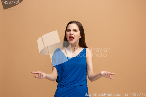 Image of The young emotional angry woman screaming on pastel studio background