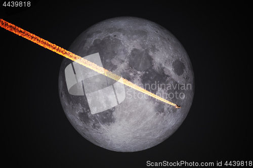 Image of a plane flight in front of the full moon by night sky