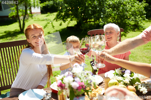 Image of happy family having dinner or summer garden party