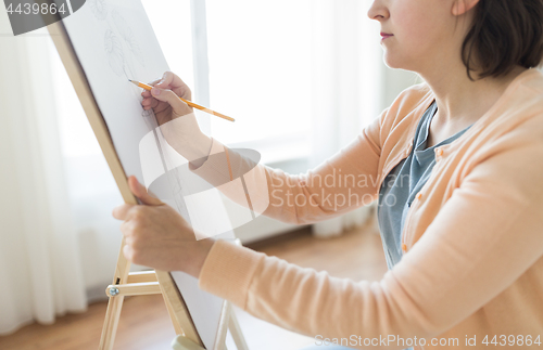 Image of artist with pencil drawing picture at art studio