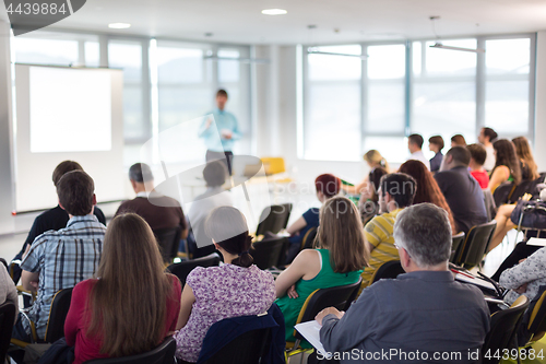 Image of Speaker giving presentation talk at business conference.