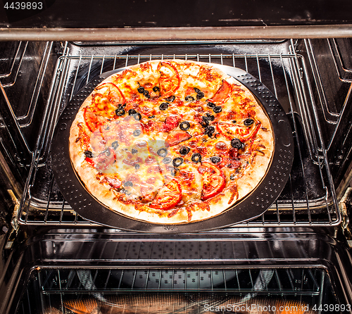 Image of Appetizing pizza in the oven.