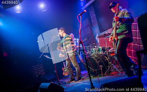 Image of Band performs on stage in a nightclub