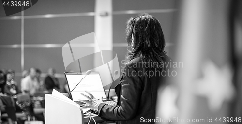 Image of Public speaker giving talk at Business Event.