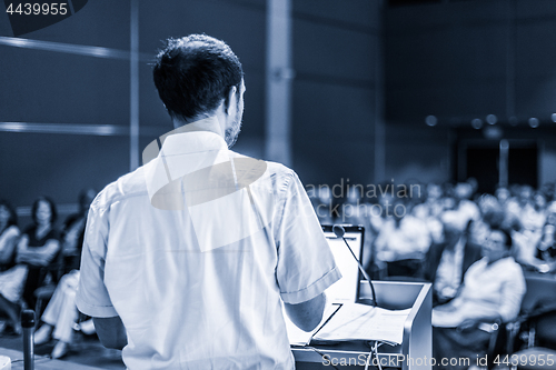 Image of Public speaker giving talk at Business Event.