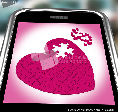 Image of Puzzle Heart On Smartphone Showing Commitment