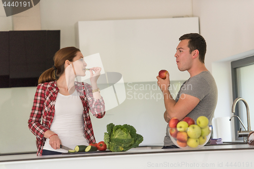 Image of Young handsome couple in the kitchen