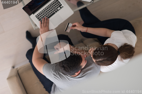 Image of happy young couple buying online