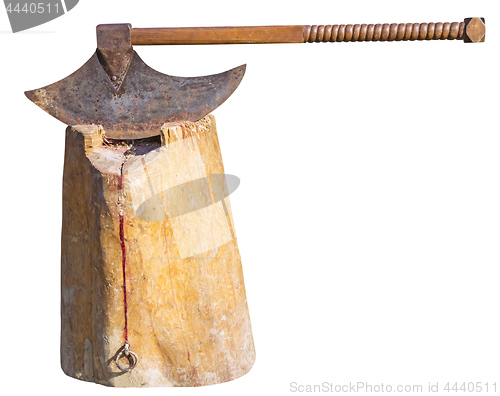 Image of The old rusty ax of the executioner on a wooden stump isolated o