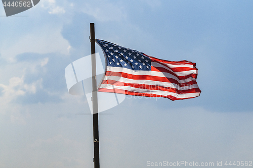 Image of The flag of USA on a flagpole