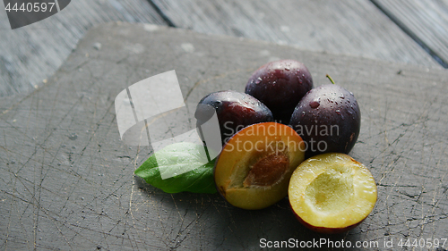 Image of Ripe plumbs on cutting board 