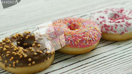 Image of Row of sweet glazed doughnuts