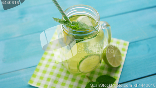 Image of Glass with lime cocktail and straw