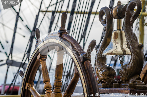 Image of Ship\'s Bell and wheel the old sailboat, close-up 