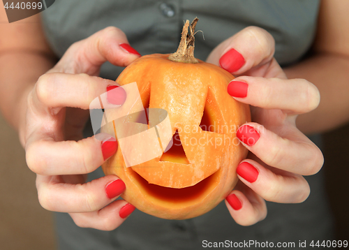 Image of pumpkin in hands for Halloween