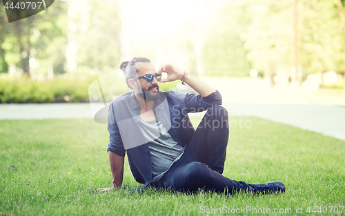 Image of man in sunglasses at city street or park