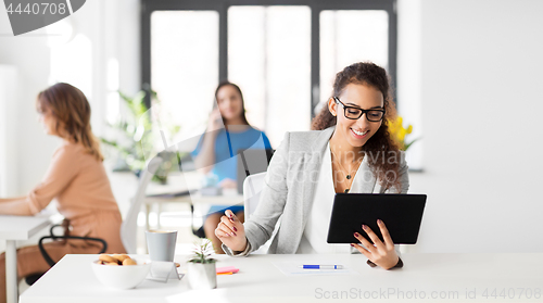 Image of businesswoman with tablet pc working at office