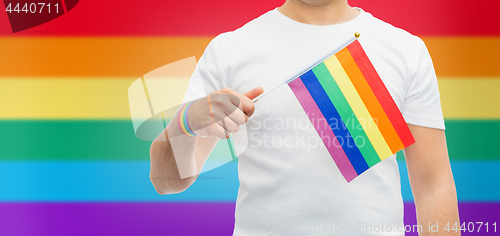 Image of man with gay pride rainbow flag and wristband