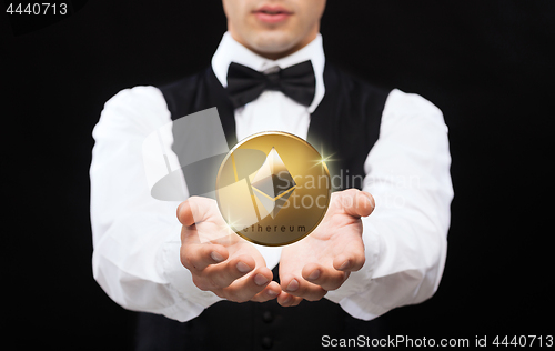 Image of close up of magician with ethereum coin