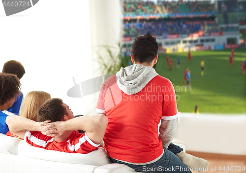 Image of friends or football fans watching soccer at home