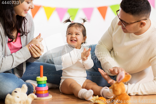 Image of baby girl with parents clapping hands